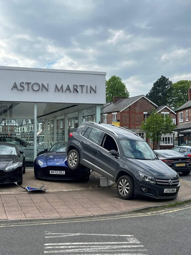 A row of Aston Martin cars parked in front of a dealership, showcasing luxury and elegance.